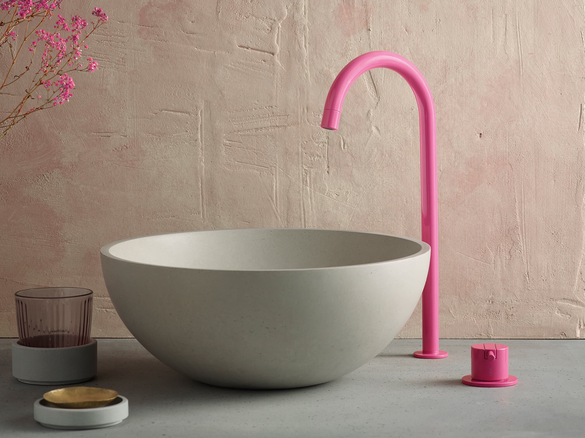 Pink gooseneck faucet with concrete vessel sink